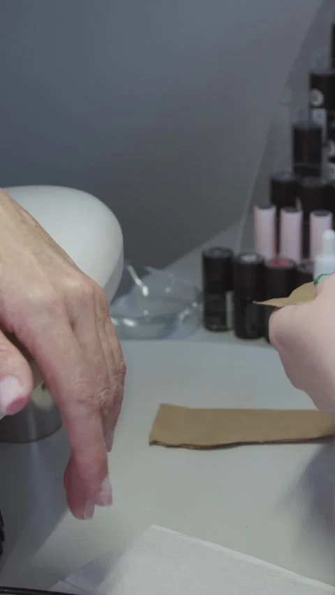 Manicure procedure - the master pulls out new set of tools from a paper bag Stock Footage 328370825