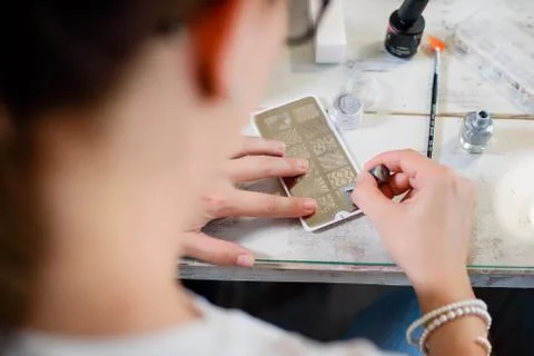 Manicure procedure with pattern and silver nails polish Stock Photos