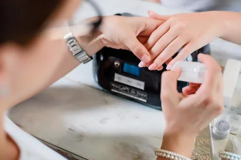 Manicure procedure with pattern and silver nails polish Stockfoto's