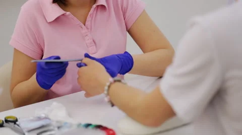 Manicure process in beauty salon, pretty smiling manicurist working on her Stock Footage 64516827