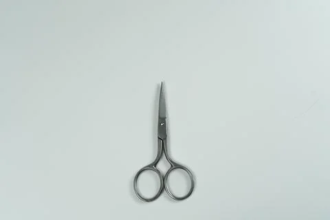 Manicure scissors displayed on a white background. Stock Photos