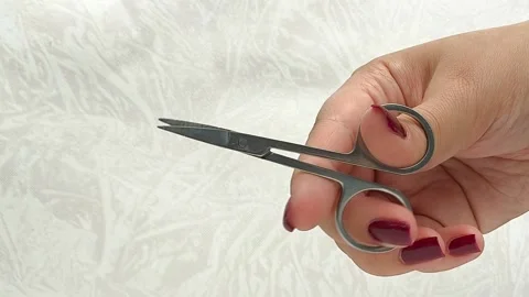 Manicure scissors in a womans hand close-up. Nail care. Stock Footage 317091609