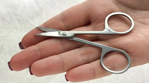 Manicure scissors in a womans hand close-up. Nail care. Stock Footage 317091756