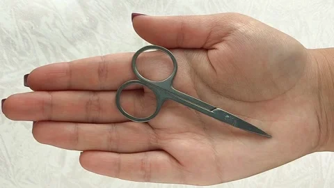 Manicure scissors in a womans hand close-up. Nail care. Stock Footage 317091767