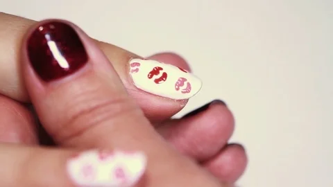 Manicure session female hand drawing red lips on white finger nail polish Stock Footage 72194348