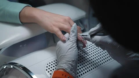 Manicure technician applies base coat on extended nail before gel polish Stock Footage 343801019