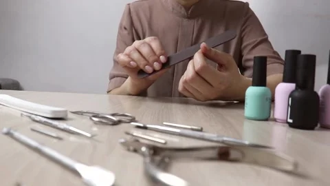 Manicure tools and nail polish lie on the table, Stock Footage 231386142