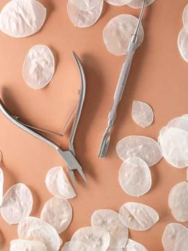 Manicure tools on a brown background in white husks. Beauty salon, aesthetics. Stock Photos