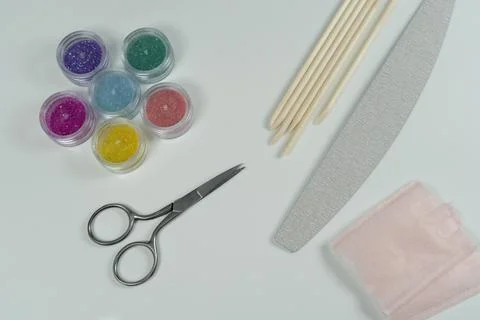 Manicure tools, including glitter, scissors, and a nail file. Stock Photos