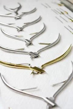 Manicure tools lying on a white background. Beauty salon, care, sterilization. Stock Photos