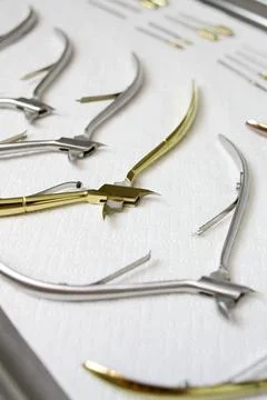 Manicure tools lying on a white background. Beauty salon, care, sterilization. Stock Photos