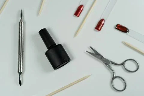 Manicure tools on a white background, including gel polish, scissors, and r.. Stock Photos