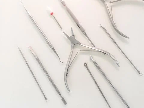 Manicure tools on a white background, top view. Beauty salon, aesthetics. Stock Photos