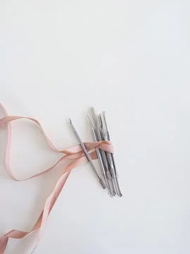 Manicure tools on white background, top view, space for text, wrapped with pink Stock Photos