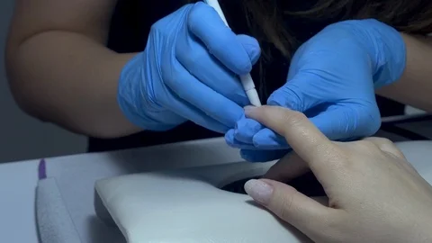 The manicure trims the nails on the arm 스톡 동영상 129092471