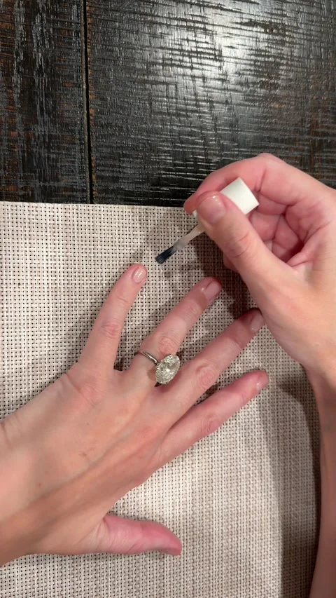 Manicure video featuring large oval diamond solitaire engagement ring Stock Footage 325876805