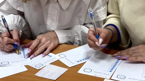 Manicured hands on answer sheets. exam. education. homework check Stock Footage 232792298