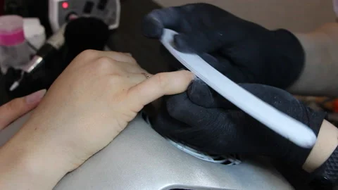 Manicurist creates the correct form of nails with a nail file. Stock Footage 111512173