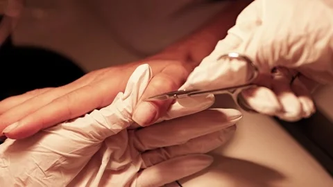 Manicurist cutting cuticles with scissors during nail treatment Stock-Footage 342314094