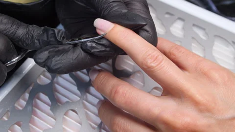 A manicurist is doing a client&amp;#039;s nails at a nail salon. Stock Footage 339780146