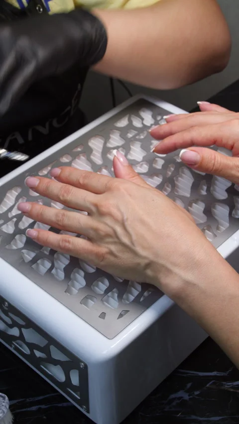 A manicurist is doing a client&amp;#039;s nails at a nail salon. Stock Footage 339780620