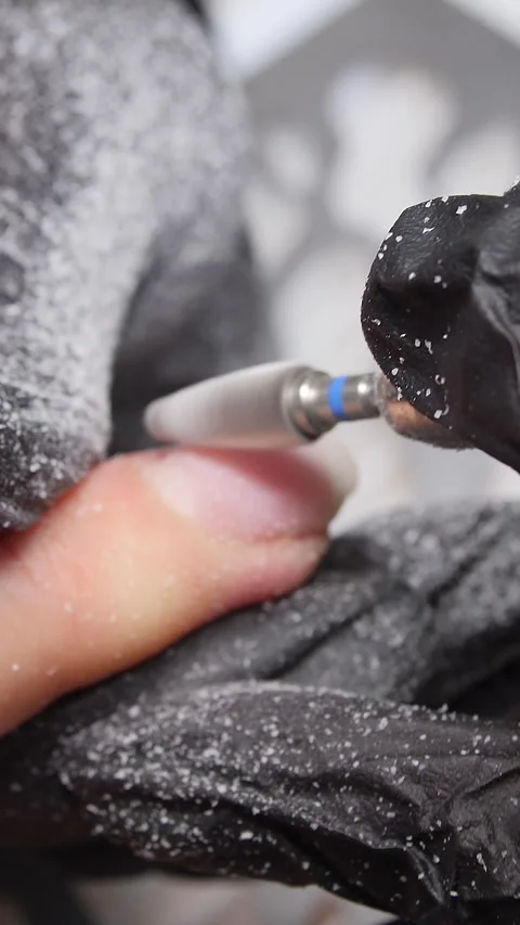 A manicurist is doing a client&amp;#039;s nails at a nail salon. Stock Footage 339781148