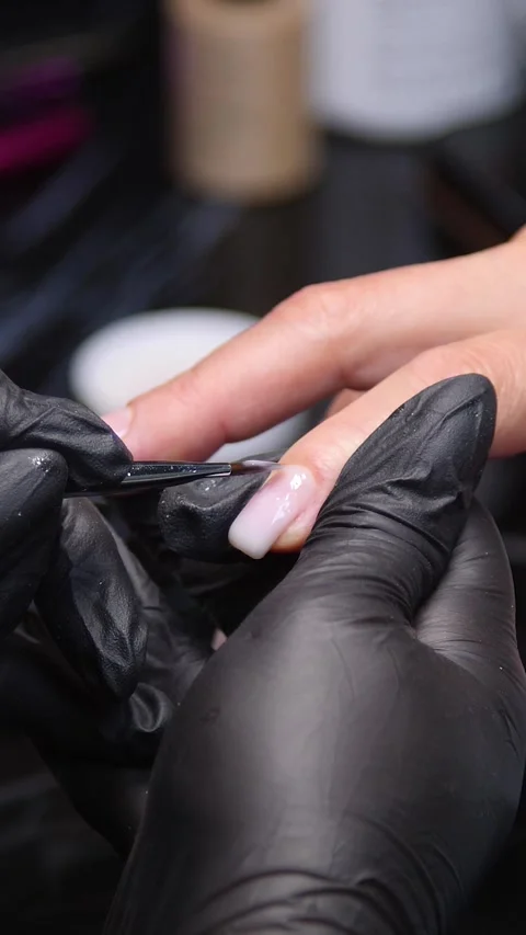 A manicurist is doing a client&amp;#039;s nails at a nail salon. Stock Footage 339781188