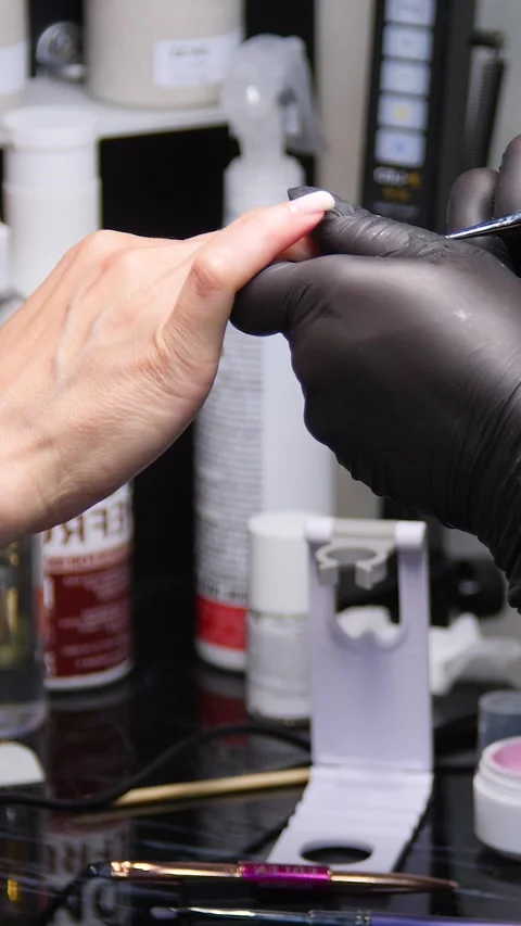 A manicurist is doing a client&amp;#039;s nails at a nail salon. Stock Footage 339781197