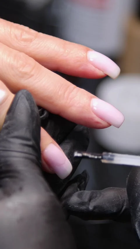 A manicurist is doing a client&amp;#039;s nails at a nail salon. Stock Footage 339781205