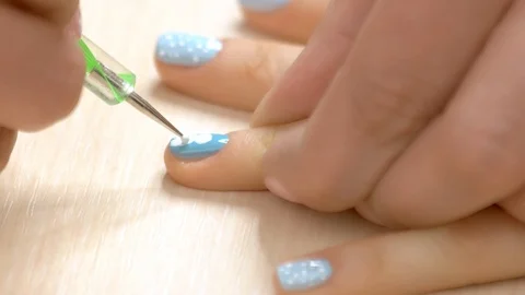 Manicurist drawing a pattern on nail. Stock Footage 90786012