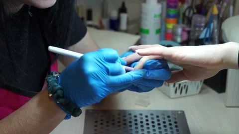 A manicurist makes the client's cuticle close-up Stock Footage 150228113