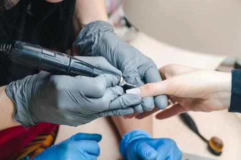 The manicurist makes a manicure using the hardware method. Nail cuticle Stock-Fotos