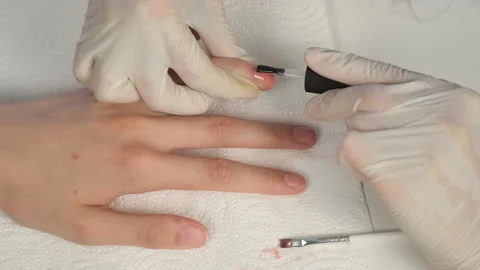 Manicurist master is applying pink gel on client nails in salon, hands closeup. Stock Footage 146167095