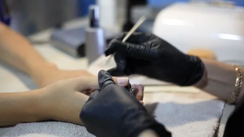 The manicurist performs the procedure of caring for the clients nails Stock Footage 162224101
