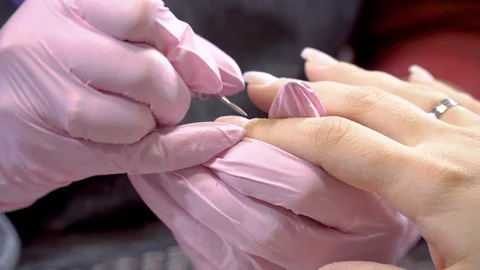 Manicurist remove cuticles using electric file nail drill Stock Footage 103283464