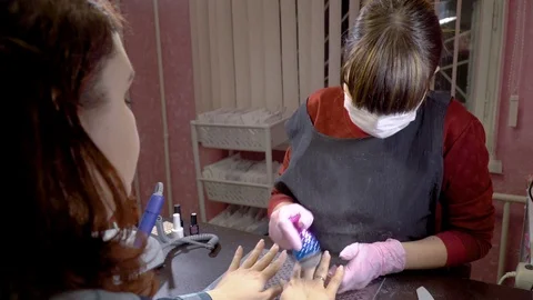 Manicurist remove nails dust from the hands of the girl Stock Footage 103283307