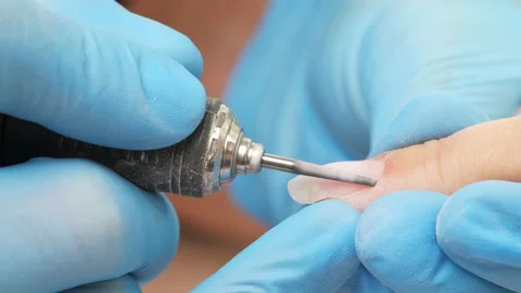 Manicurist removing cuticles. Processing of rough cuticles and lateral folds  Stock Footage 162513711