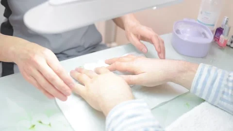 A manicurist saws a man's nails Stock Footage 132105137