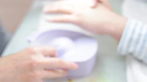 A manicurist saws a man's nails Stock Footage 132105186