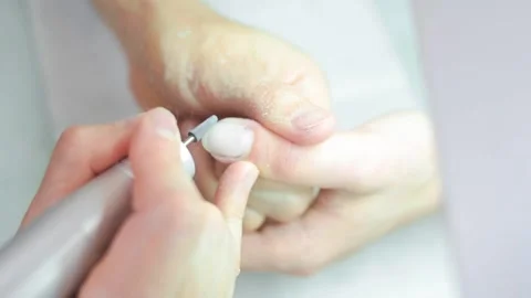A manicurist saws a man's nails Stock Footage 132105299