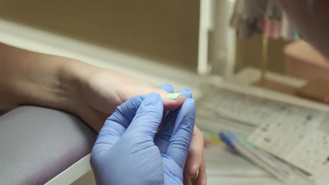 Manicurist treating client with tools and polish. Manicure service in beauty Stock Footage 247061954