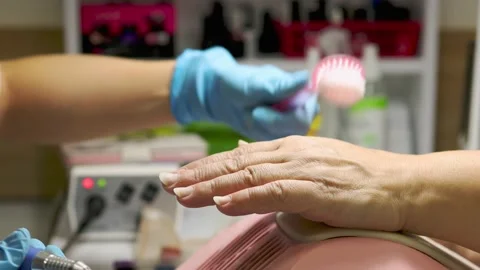 Manicurist using electric nail drill machine before nail varnish apply Stock Footage 149439647