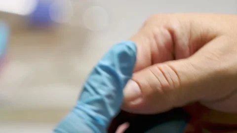 Manicurist using electric nail drill machine before nail varnish apply Stock Footage 149439740