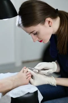 Manicurist working with forceps Stock Photos