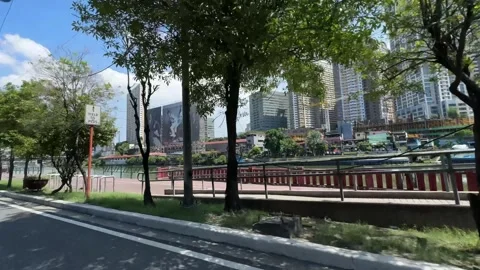 Manila riverside panning shot featuring Mandaluyong city skyline 4k Stock Footage 337439993