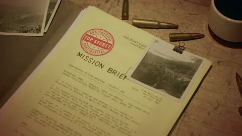 A manilla folder containing a 'Secret Mission Brief' is lit by subdued light Stock Footage 233327468
