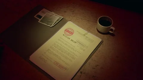 A manilla folder containing a 'Secret Mission Brief' is lit by subdued light Stock Footage 233327702