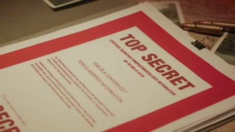 A manilla folder containing 'Top Secret' documents is lit by subdued light Stock Footage 233283625