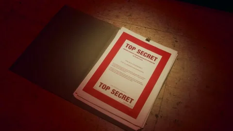 A manilla folder containing 'Top Secret' documents is lit by subdued light Stock Footage 233284887