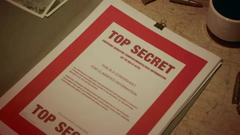 A manilla folder containing 'Top Secret' documents is lit by subdued light Stock Footage 233327579